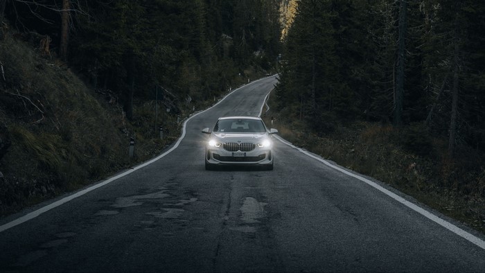 White BMW driving on a winding mountain road