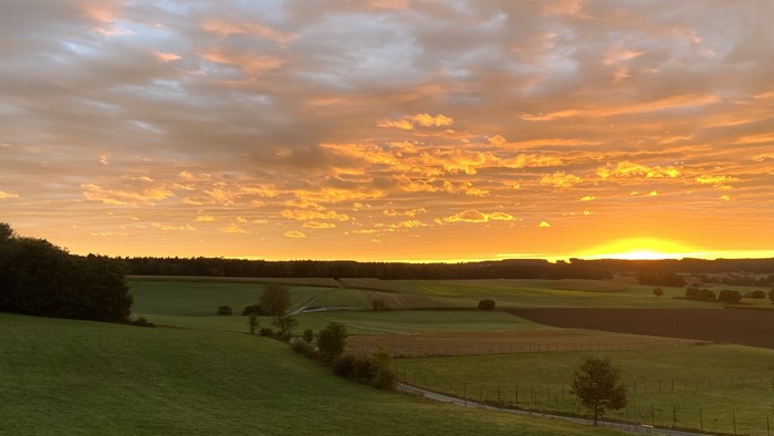 Sunrise over rolling hills and fields