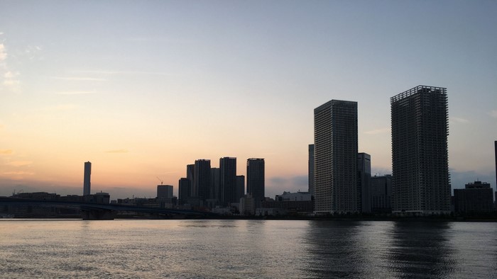 Skyscrapers at sunset over water