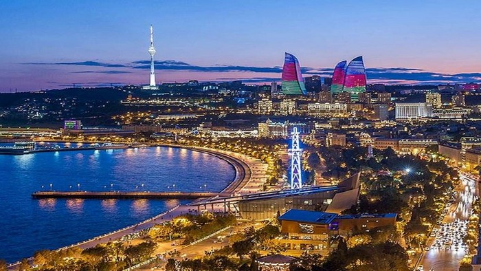 Baku cityscape with Flame Towers and TV tower at dusk
