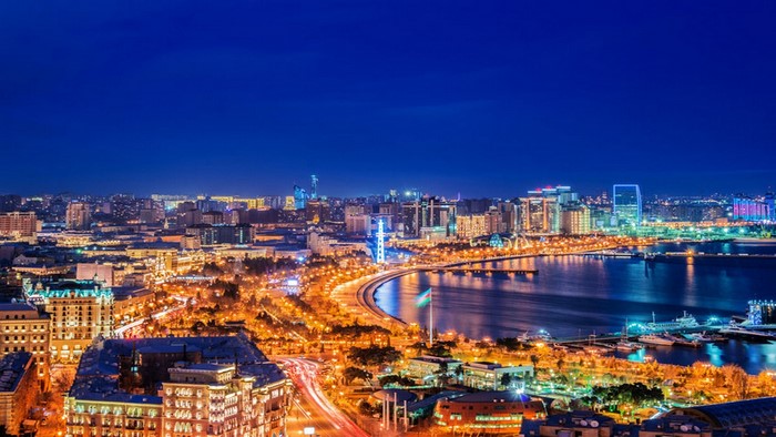 Baku cityscape at night with illuminated buildings and bay