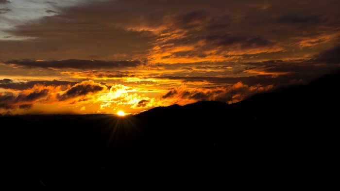 Sunset over dark mountains
