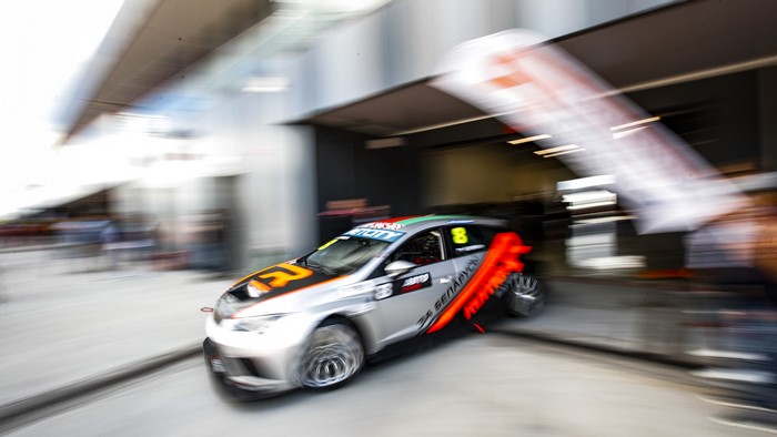 Race car number 8 entering a garage
