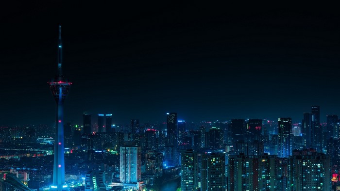 Night city skyline with a tall tower