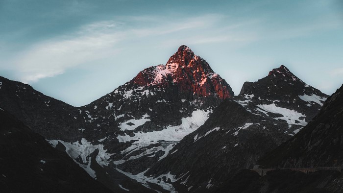 Snow-capped mountain peak at sunset
