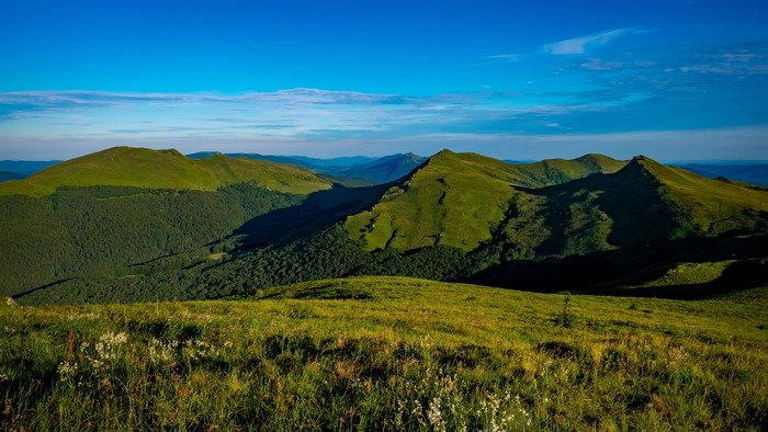 Green mountains under a blue sky