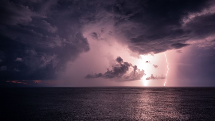 Lightning strike over the ocean during a storm