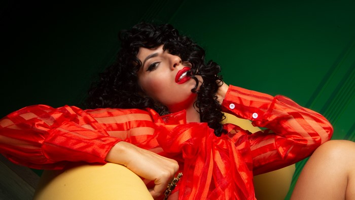 Woman in red shirt with curly hair