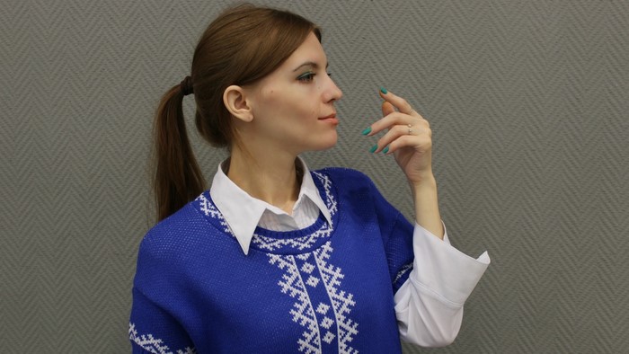 Woman in blue sweater with white pattern