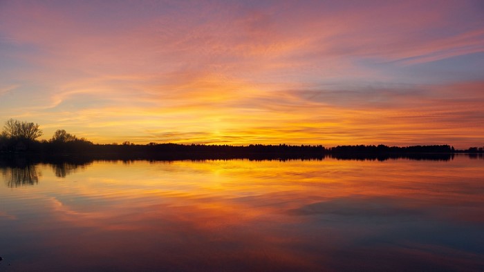 Sunset over a calm lake with colorful sky