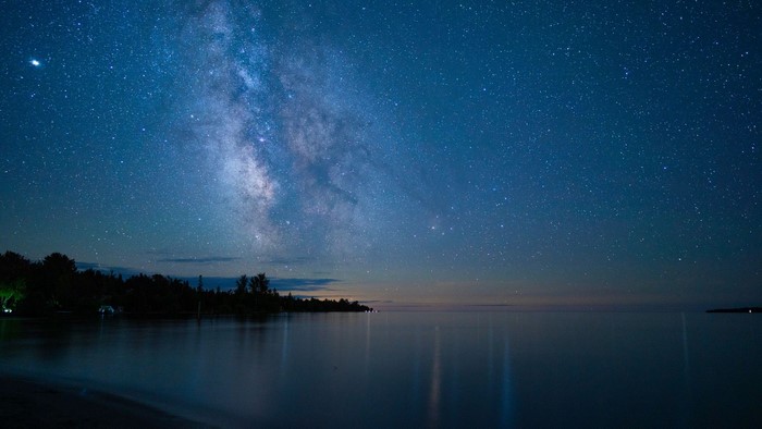 Milky Way over a calm lake at night