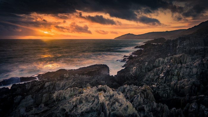 Sunset over rocky coastline