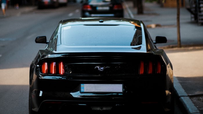 Black Ford Mustang parked on street