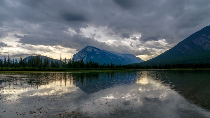 Lake and Mountains Under Cloudy Sky