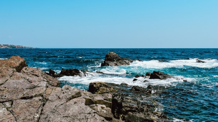 Rocky Coastline with Blue Ocean and Clear Sky