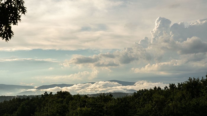 Clouds over mountains and forest