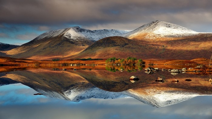 Snow-capped mountains reflected in a lake