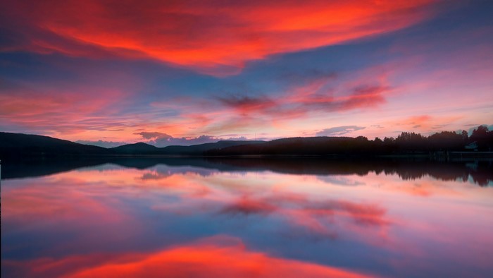 4K Sunset Over Calm Lake with Dramatic Clouds