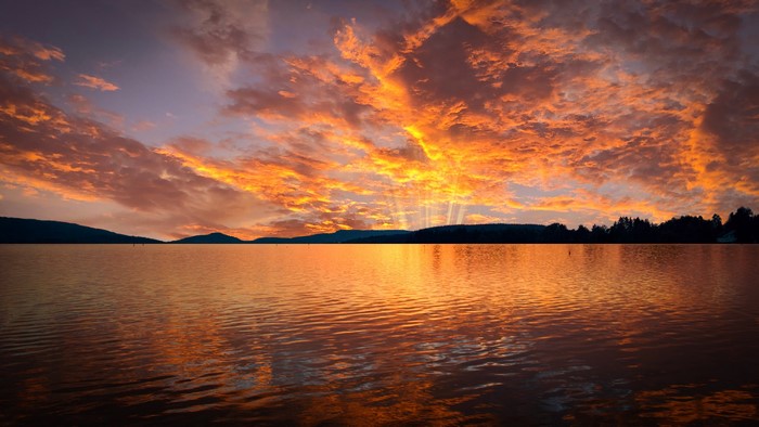 4K Sunset Over Water with Dramatic Clouds