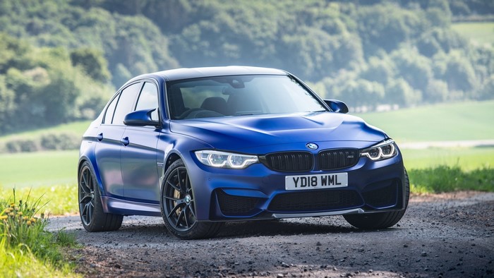 Blue BMW M3 F80 on a dirt road