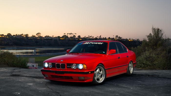 Red BMW M Power Sedan at Sunset