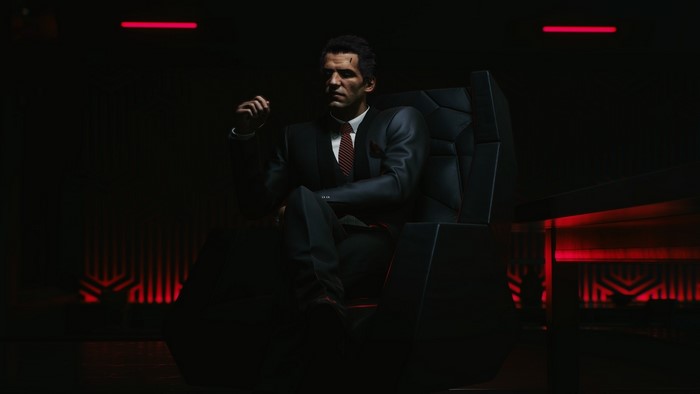 Man in suit sitting in chair in Cyberpunk 2077