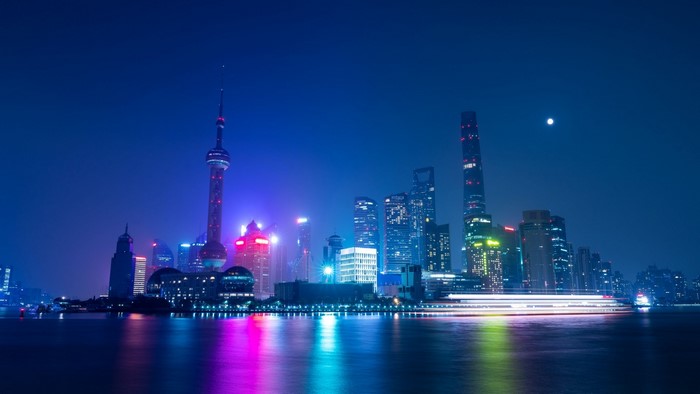 Night city skyline with Oriental Pearl Tower and river