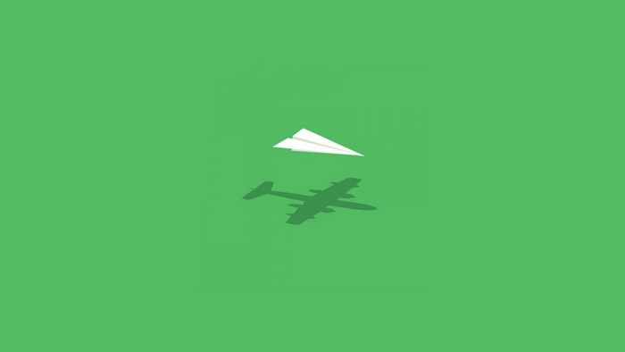 Paper airplane casting shadow of a bomber plane