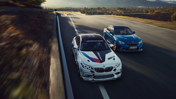 Two BMW M cars on a race track