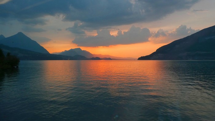 Sunset over a lake with mountains