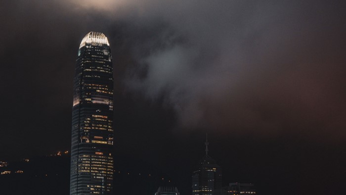 Hong Kong skyscrapers at night with clouds