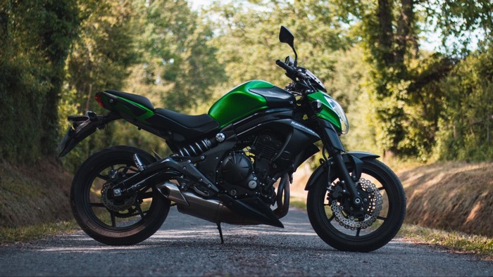 Green Kawasaki Er-6n motorcycle on a road