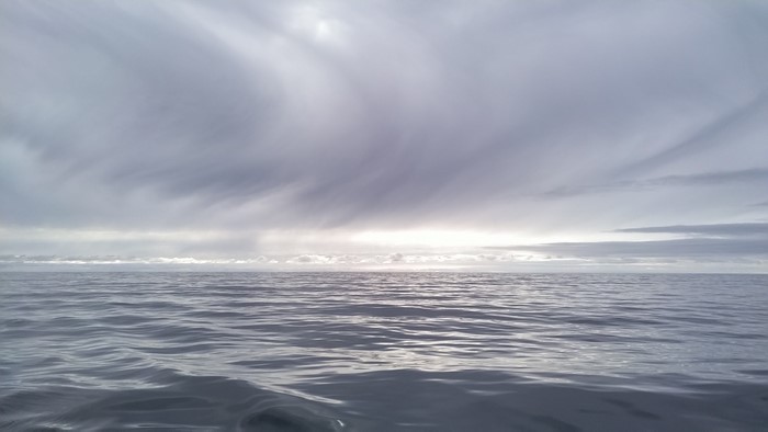 Ocean under cloudy sky