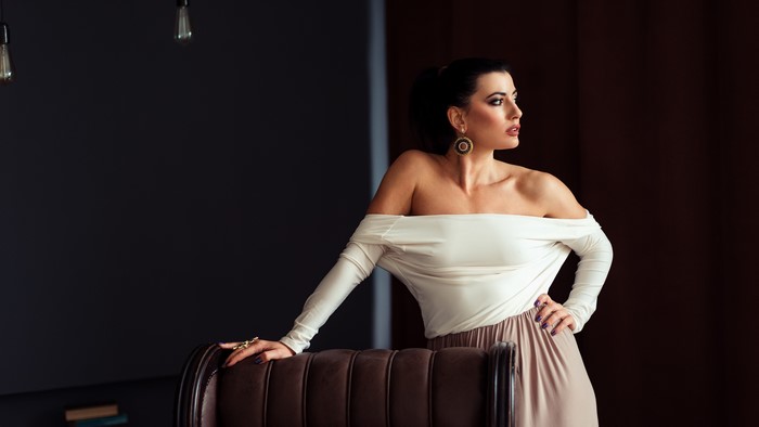 Woman in off-the-shoulder top and skirt