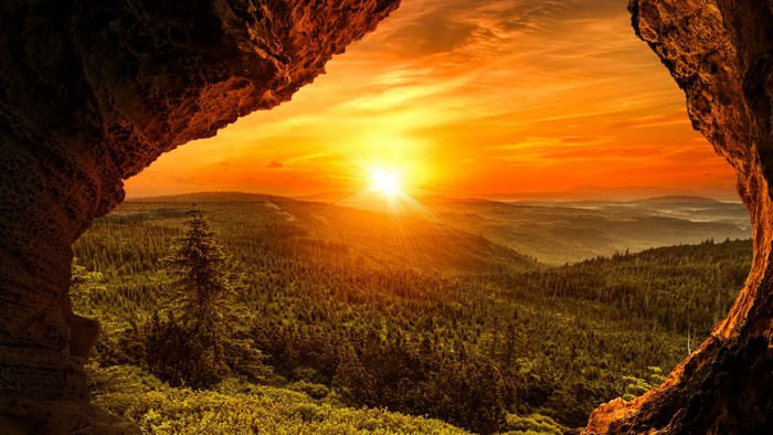 4K Sunset Over Forested Mountains from Cave