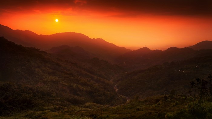 Sunset over misty mountains