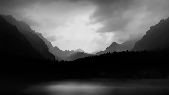 Misty mountains and lake in black and white