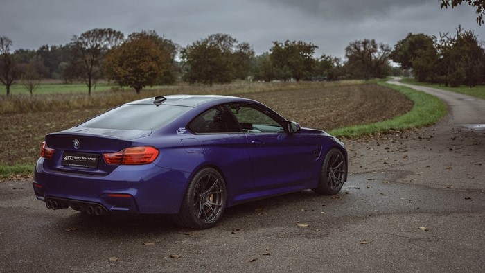 Purple BMW M4 Coupe on a Wet Road