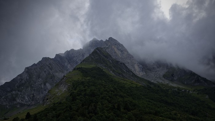 Misty Mountain Peaks with Green Slopes
