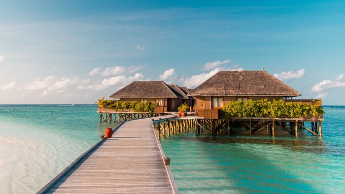 Overwater bungalows with a wooden walkway in the Maldives