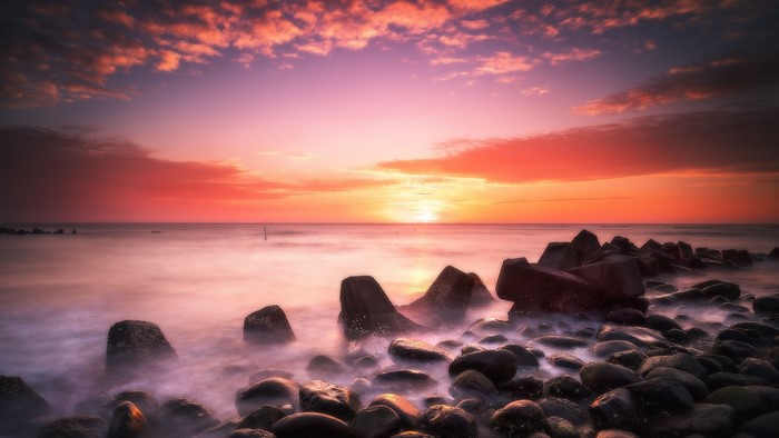 Sunset over the ocean with rocks