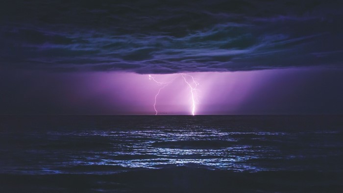 Lightning strikes the ocean during a storm
