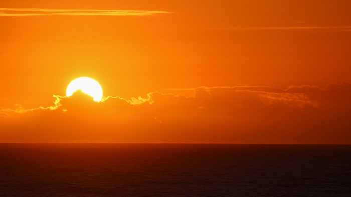 Sunset over the ocean with clouds