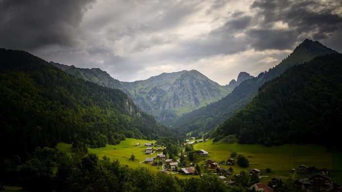 Village nestled in a green mountain valley