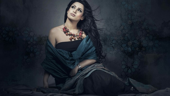 Woman with dark hair and jewelry