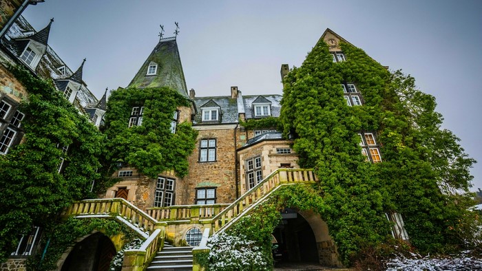 Stone castle covered in ivy with snow