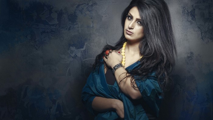 Woman with dark hair and jewelry