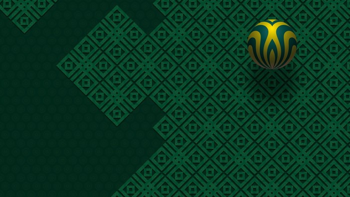 Ball with yellow and green pattern on a green patterned surface