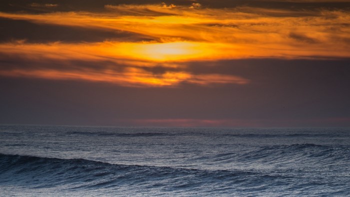Sunset over ocean waves