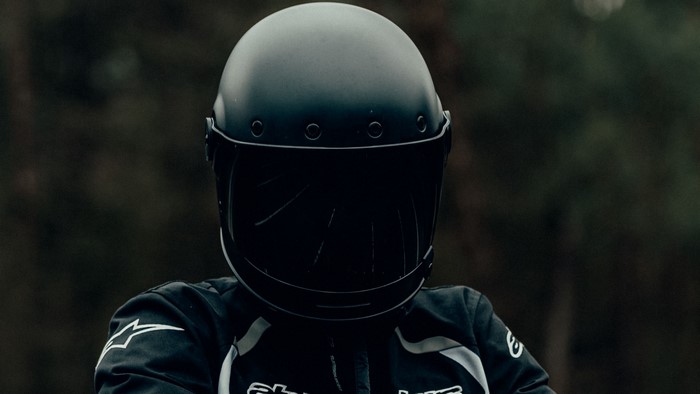 Motorcyclist wearing a black helmet and jacket
